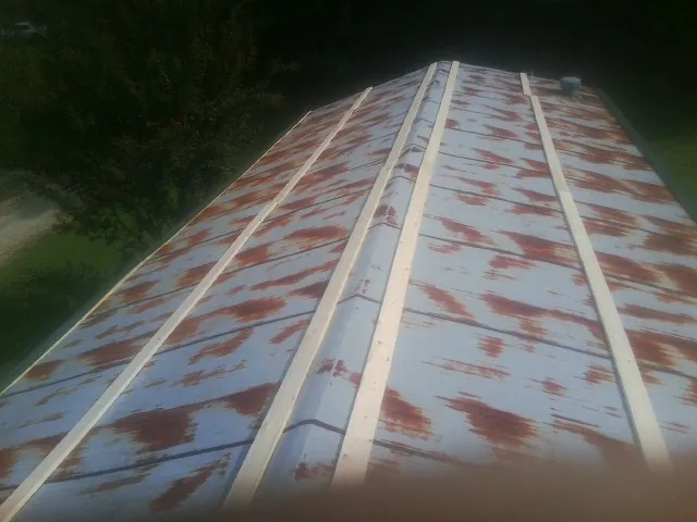 Rusted metal roof panels with new wood purlins before replacement — Storm Damage Roof Repair in Fort Riley by Roofing Brothers