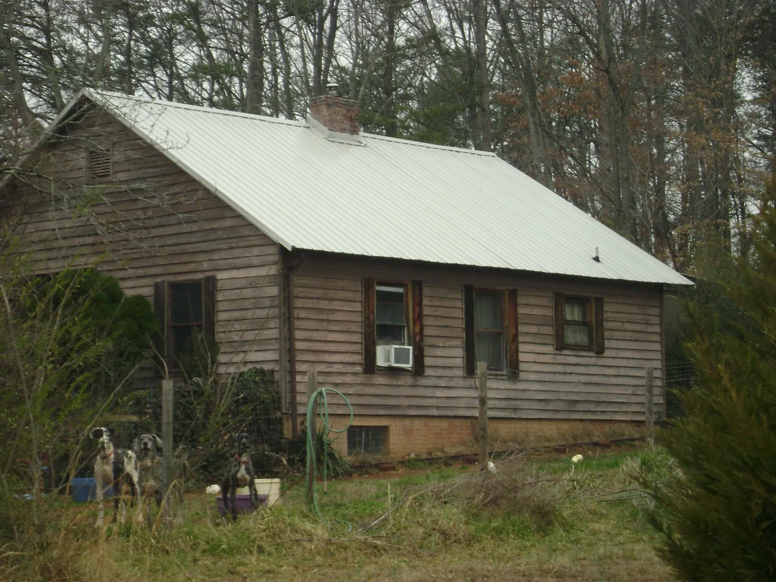 White metal roof on an old wood sided farmhouse, from a Metal Roof Installation job in Fort Riley